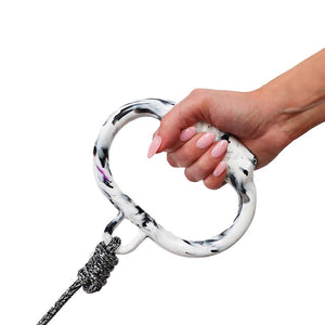 Hand holding black and white recycled dog leash