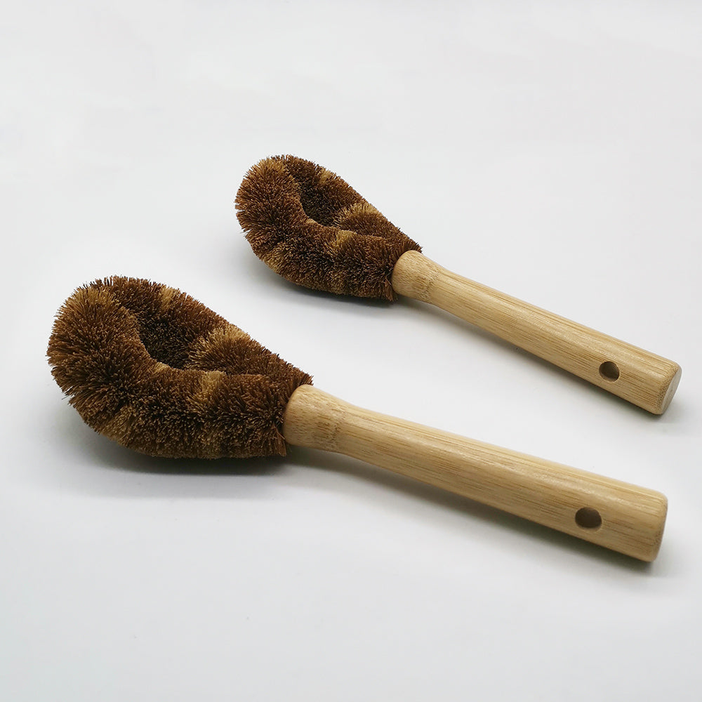 two dishwashing brushes wooden on white