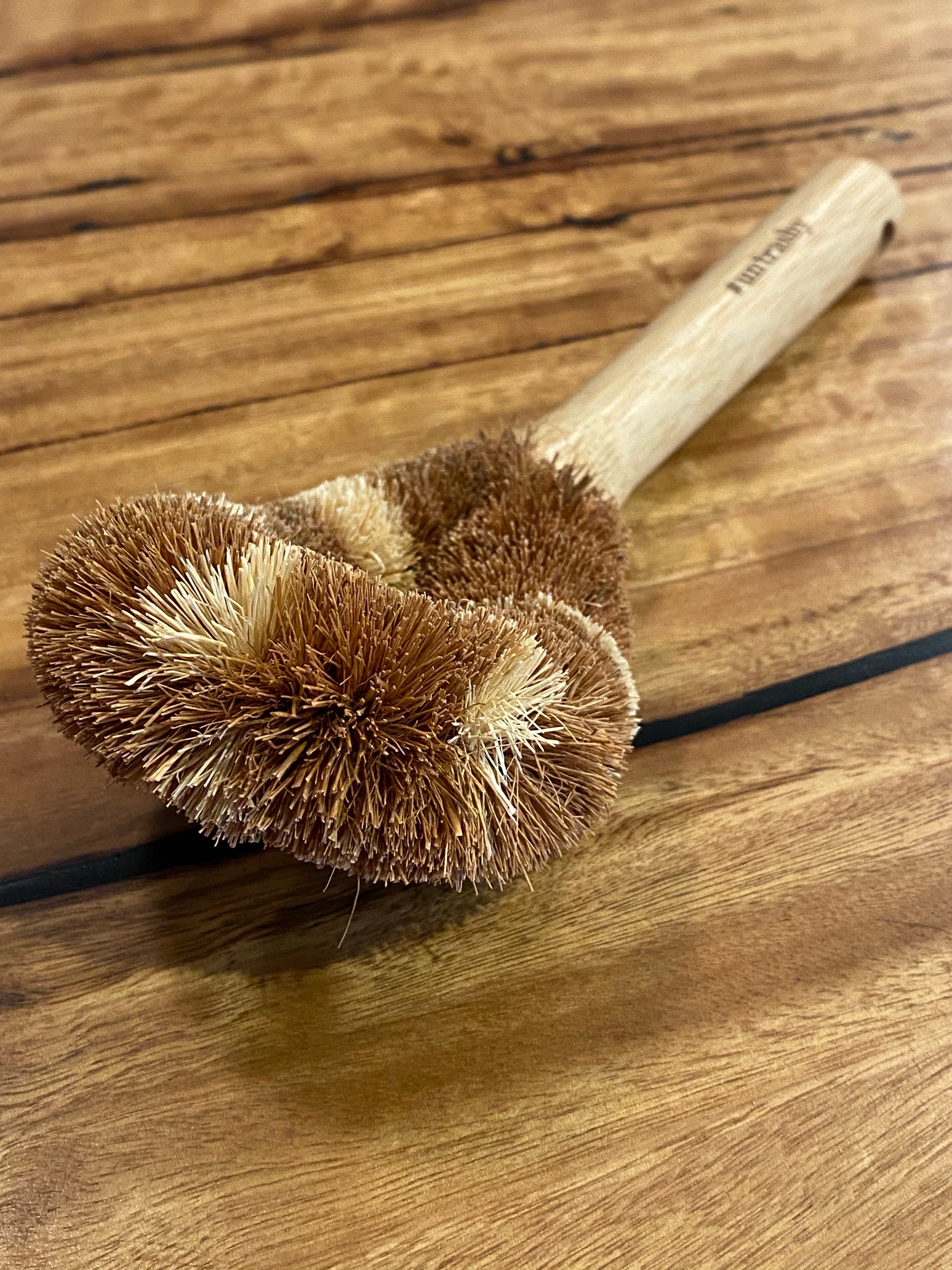 coconut husk dish brush on wooden table