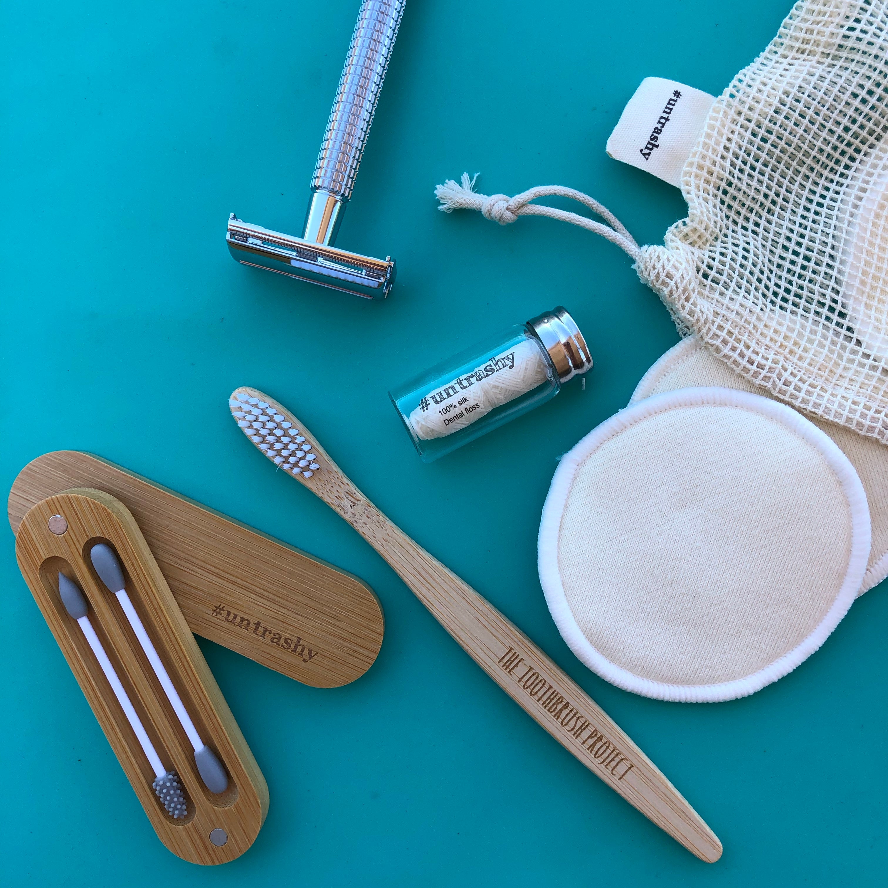 safety razor, makeup wipes, floss toothbrush and earbuds